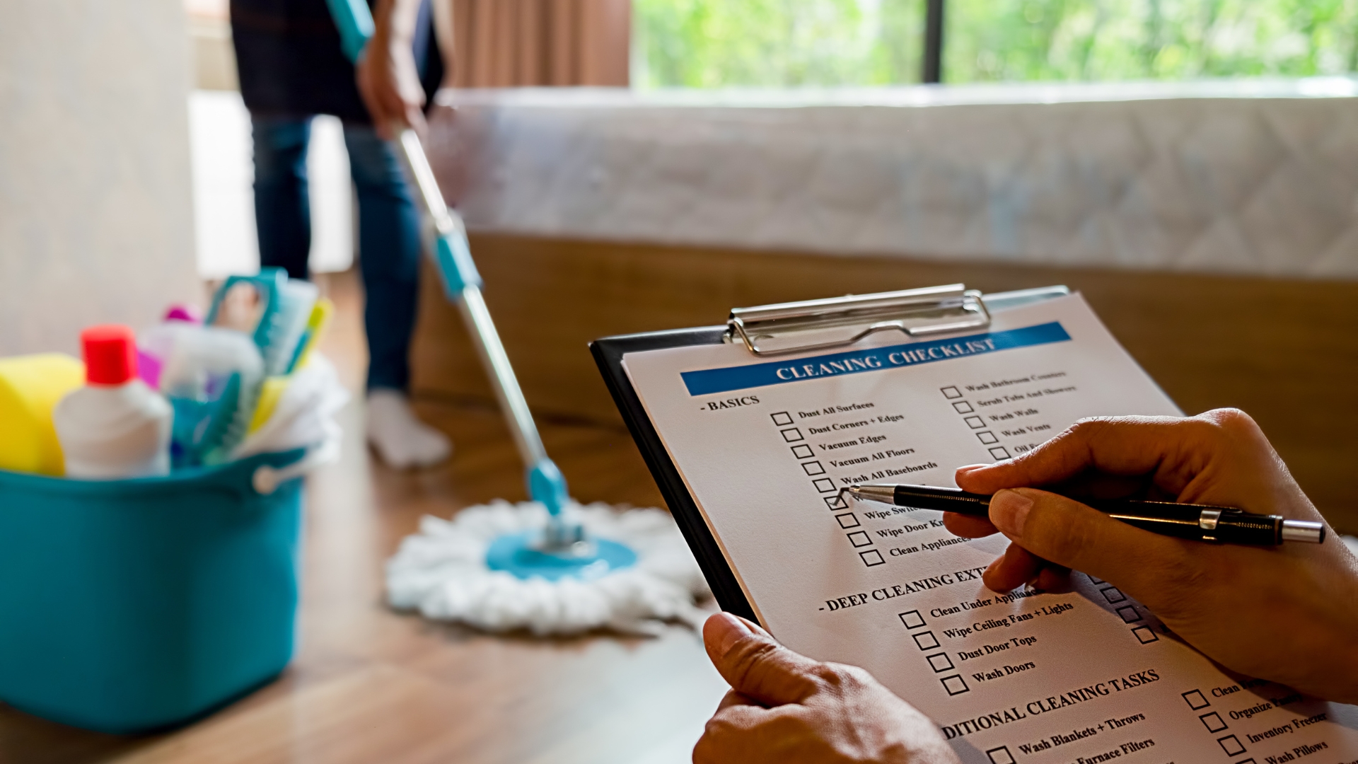 A person holding a clipboard with a cleaning checklist on it