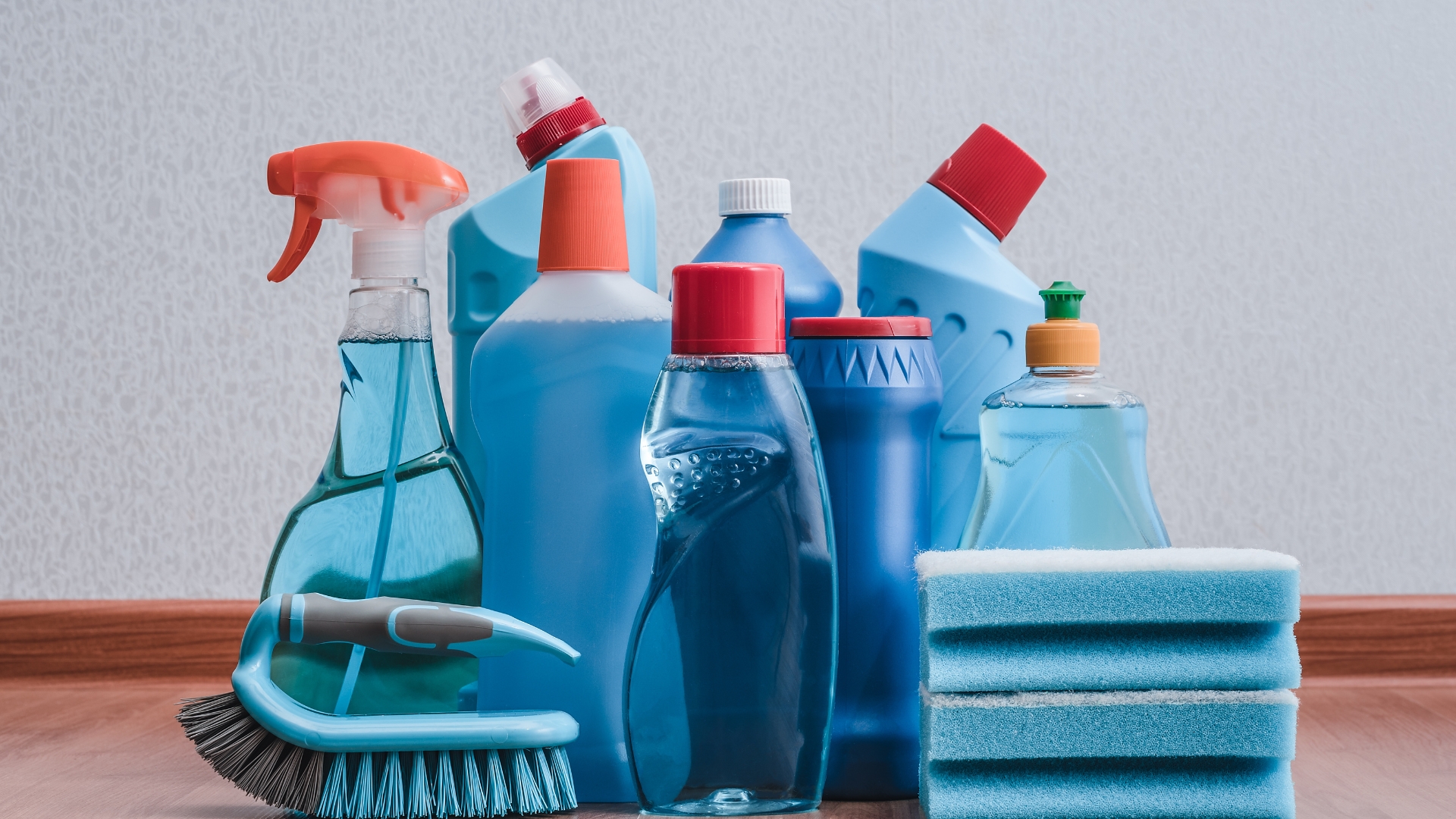 A pile of cleaning supplies sitting on top of a wooden floor